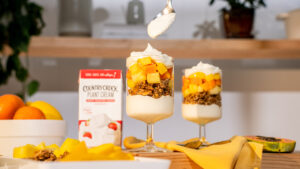 Bright sunny kitchen scene showcasing a delicious parfait with fruit, granola, and a popular food product. Perfect for highlighting your CPG brand through high-quality food videography and photography. Enhance your marketing with visually appealing parfait setups that attract and engage your audience.