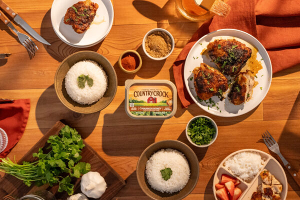 Air Fryer Glazed Chicken Chicken and rice elegantly presented on a rustic wooden surface, curated for a warmly styled family dinner setting.