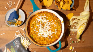 Cheese corn dip styled on a wooden surface to highlight the featured product.