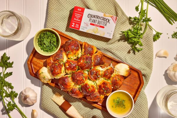 Garlic Pull Apart Bread Garlic pull-apart bread on a green towel, with the product featured in pretty studio lighting, emphasizing the warm and inviting presentation.