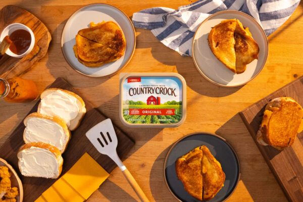 BBQ Chicken gGrilled Cheese Grilled cheese sandwich with the product prominently displayed in the center on a wooden table, highlighting the mouth-watering appeal and product integration.