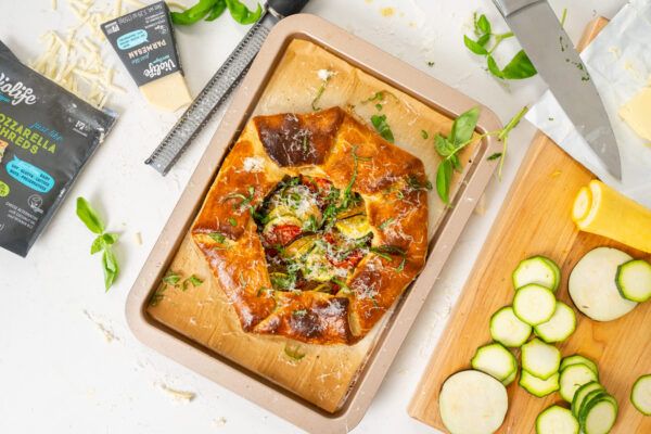 Ratatouille gallette styled on a marble countertop to effectively market the food brand featured for social media. Styled with extra ingredients, herbs.