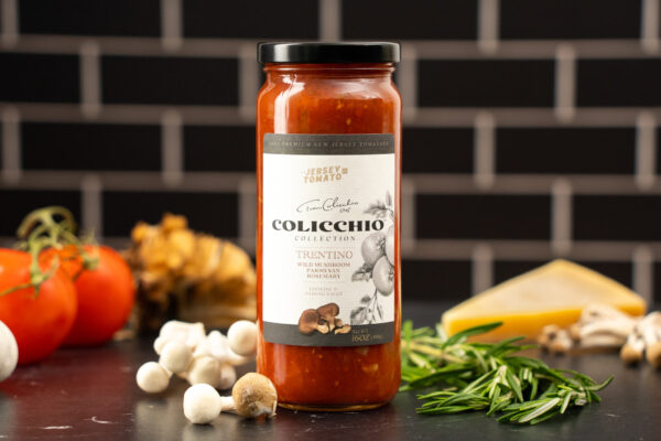 Close-up photography of tomato sauce highlighting fresh ingredients like tomatoes, garlic, and herbs, emphasizing the rich flavor cues ideal for food brand marketing.